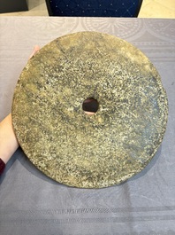 A Chinese archaic calcified jade 'bi' disc on an iron stand, possibly Zhou