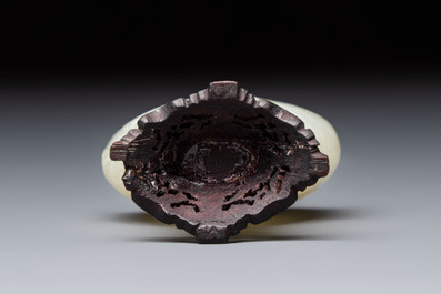 A Chinese carved white jade 'Geese' snuff bottle with a wooden stand, 18/19th C.