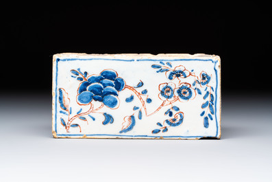 A blue, white and iron-red decorated English Delftware flower brick vase, 18th C.