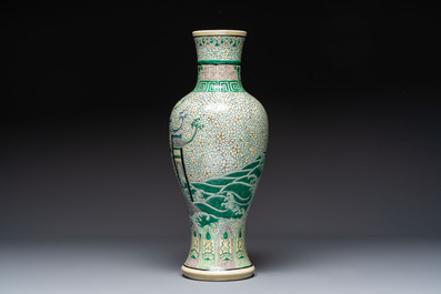 A Chinese verte biscuit 'Dragon Gate Carp 鯉躍龍門' vase on a wooden stand, Xuande mark, 19th C.