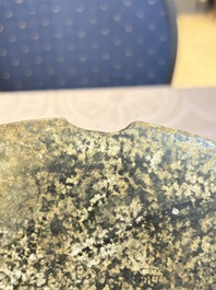 A Chinese archaic calcified jade 'bi' disc on an iron stand, possibly Zhou