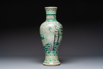 A Chinese verte biscuit 'Dragon Gate Carp 鯉躍龍門' vase on a wooden stand, Xuande mark, 19th C.