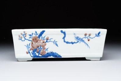 A Chinese blue, white and copper-red rectangular jardini&egrave;re with birds among flowering branches, 20th C.