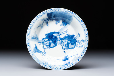 A Chinese blue and white 'Hunting Scene' cup and saucer, Kangxi