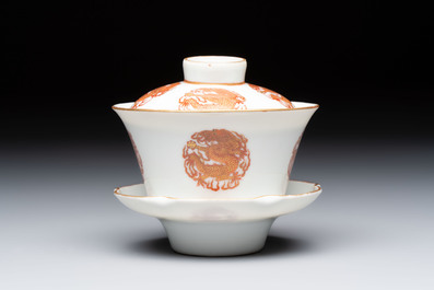 A fine Chinese iron-red gilt-decorated covered teabowl with a stand, Guangxu mark and of the period