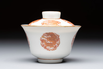 A fine Chinese iron-red gilt-decorated covered teabowl with a stand, Guangxu mark and of the period