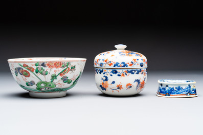 Three Chinese blue and white, famille rose and black-glazed covered teapots, a salt, an Imari-style covered bowl, and a famille verte bowl, 18th C.