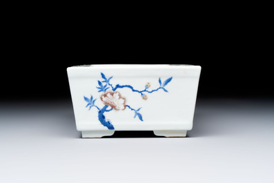 A Chinese blue, white and copper-red rectangular jardini&egrave;re with birds among flowering branches, 20th C.