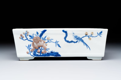 A Chinese blue, white and copper-red rectangular jardini&egrave;re with birds among flowering branches, 20th C.