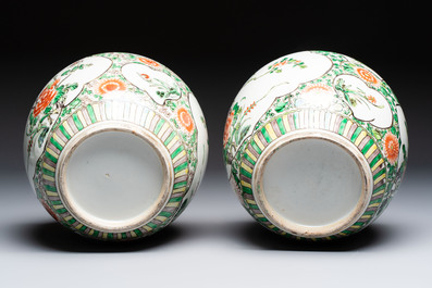 A pair of Chinese famille verte 'Floral' jars with wooden covers, 19th C.