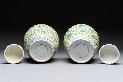 A rare pair of Chinese famille verte yellow-ground 'Flower Scroll' covered vases, Kangxi