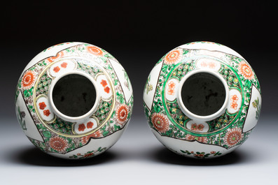 A pair of Chinese famille verte 'Floral' jars with wooden covers, 19th C.