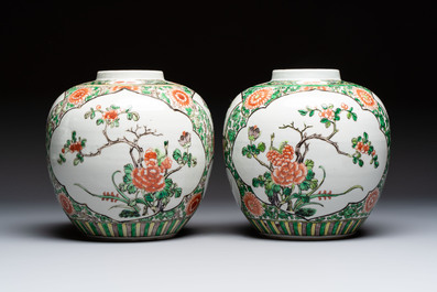 A pair of Chinese famille verte 'Floral' jars with wooden covers, 19th C.
