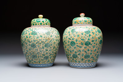 A rare pair of Chinese famille verte yellow-ground 'Flower Scroll' covered vases, Kangxi