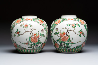 A pair of Chinese famille verte 'Floral' jars with wooden covers, 19th C.