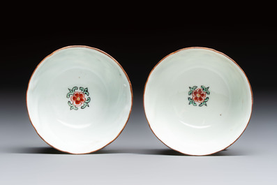 Two Dutch-decorated Chinese cups and saucers with parrots among flowering branches, 18th C.