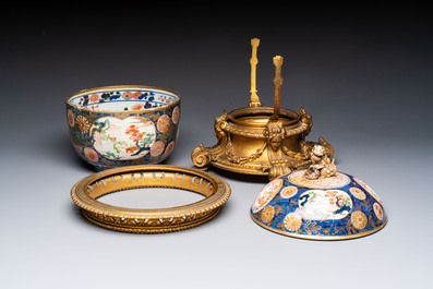 Two Japanese Imari covered bowls, one mounted in silver and wood and the other with gilt-bronze mounts, Meiji, 19th C.