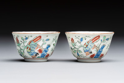 Two Dutch-decorated Chinese cups and saucers with parrots among flowering branches, 18th C.