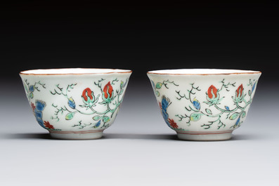Two Dutch-decorated Chinese cups and saucers with parrots among flowering branches, 18th C.