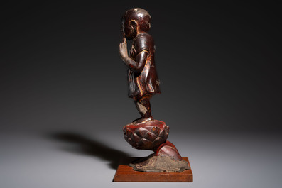 A rare Chinese gilt-lacquered bronze Buddha standing on a lotus throne, Ming