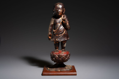 A rare Chinese gilt-lacquered bronze Buddha standing on a lotus throne, Ming