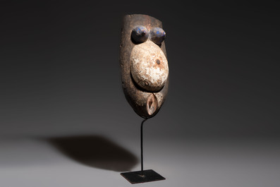 A polychromed wooden fertility belly mask from the Yoruba people, West Africa, 20th C.