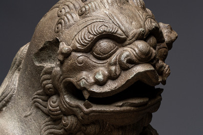 A pair of Chinese carved stone Buddhist lions on later red-lacquered wooden stands, Fujian, Qing