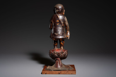 A rare Chinese gilt-lacquered bronze Buddha standing on a lotus throne, Ming