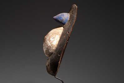 A polychromed wooden fertility belly mask from the Yoruba people, West Africa, 20th C.