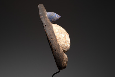 A polychromed wooden fertility belly mask from the Yoruba people, West Africa, 20th C.