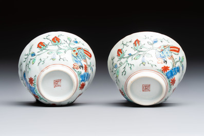 Two Dutch-decorated Chinese cups and saucers with parrots among flowering branches, 18th C.