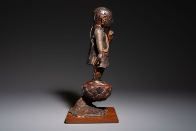 A rare Chinese gilt-lacquered bronze Buddha standing on a lotus throne, Ming