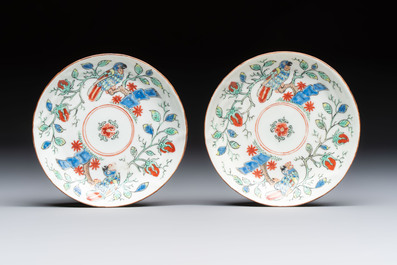 Two Dutch-decorated Chinese cups and saucers with parrots among flowering branches, 18th C.