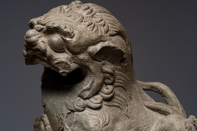 A pair of Chinese carved stone Buddhist lions on later red-lacquered wooden stands, Fujian, Qing