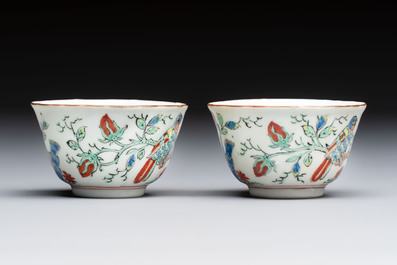Two Dutch-decorated Chinese cups and saucers with parrots among flowering branches, 18th C.