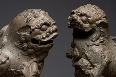 A pair of Chinese carved stone Buddhist lions on later red-lacquered wooden stands, Fujian, Qing
