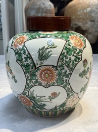 A pair of Chinese famille verte 'Floral' jars with wooden covers, 19th C.