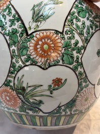 A pair of Chinese famille verte 'Floral' jars with wooden covers, 19th C.