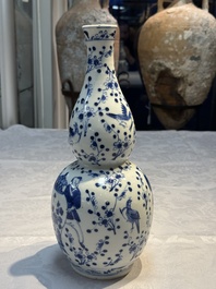 Three Chinese blue and white vases, one covered, Kangxi mark, 19th C. and later