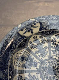 A pair of large Chinese blue and white 'Peacock Border' chargers with floral design, Kangxi