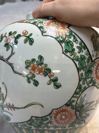 A pair of Chinese famille verte 'Floral' jars with wooden covers, 19th C.