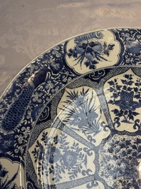 A pair of large Chinese blue and white 'Peacock Border' chargers with floral design, Kangxi