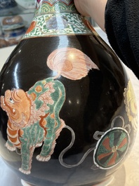 A rare Chinese famille verte black- and ruby-ground 'Buddhist Lions' vase, Kangxi