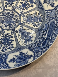 A pair of large Chinese blue and white 'Peacock Border' chargers with floral design, Kangxi