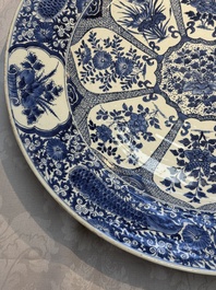 A pair of large Chinese blue and white 'Peacock Border' chargers with floral design, Kangxi