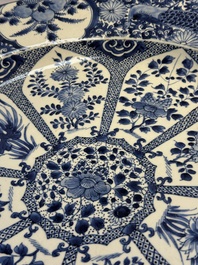 A pair of large Chinese blue and white 'Peacock Border' chargers with floral design, Kangxi