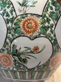 A pair of Chinese famille verte 'Floral' jars with wooden covers, 19th C.