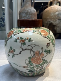 A pair of Chinese famille verte 'Floral' jars with wooden covers, 19th C.