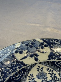 A pair of large Chinese blue and white 'Peacock Border' chargers with floral design, Kangxi