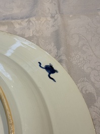 A pair of large Chinese blue and white 'Peacock Border' chargers with floral design, Kangxi